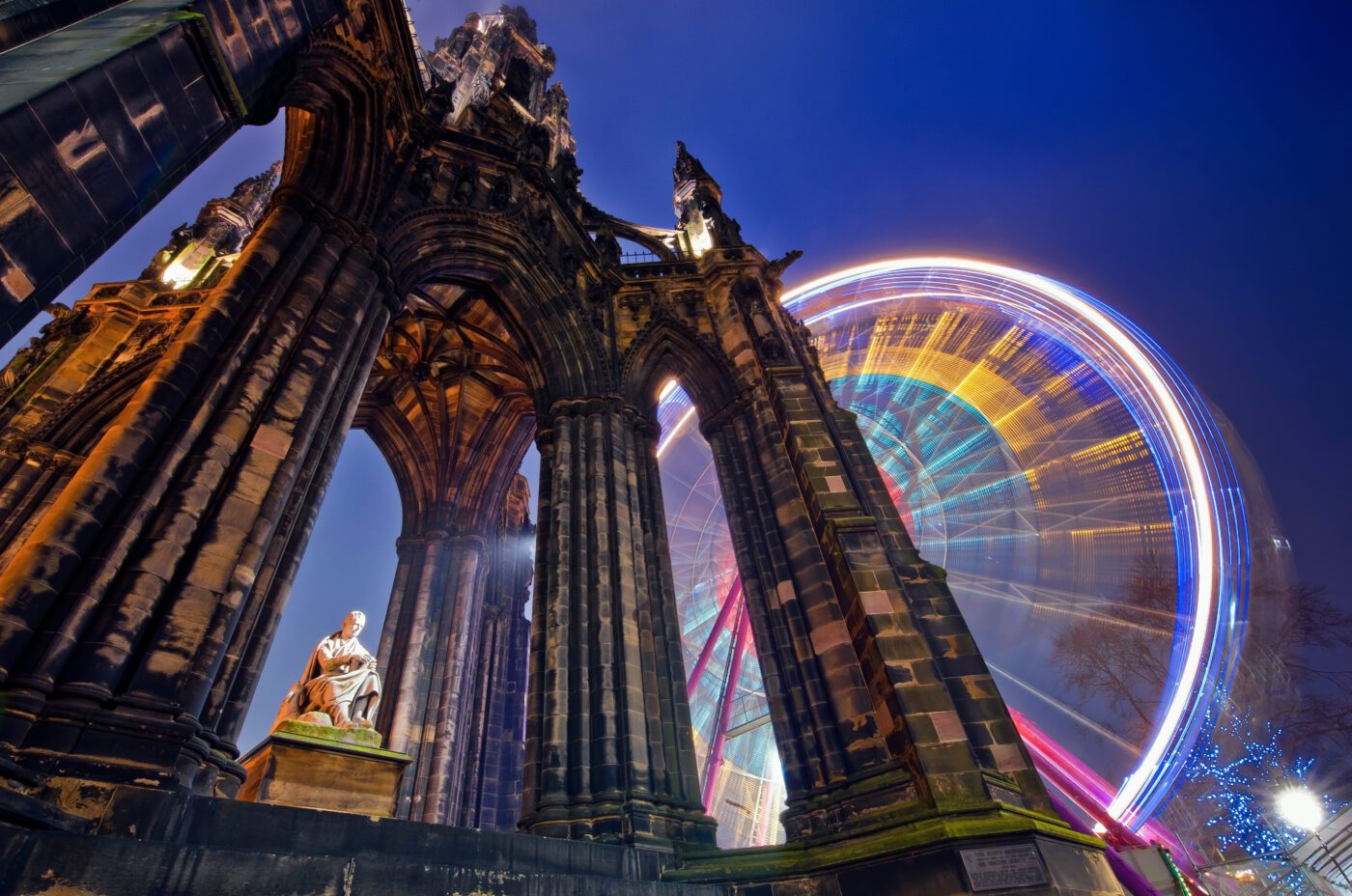 Scott Monument in Edinburgh, with the Edinburgh Princes Street Christmas market behind it.