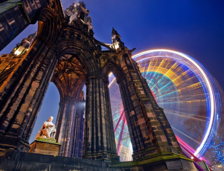 Scott Monument in Edinburgh, with the Edinburgh Princes Street Christmas market behind it.