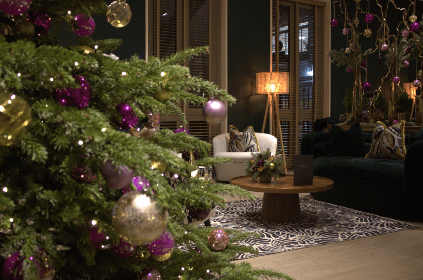 The Resident Soho at Christmas. The lounge area includes a decorated Christmas tree, a sofa and coffee table.