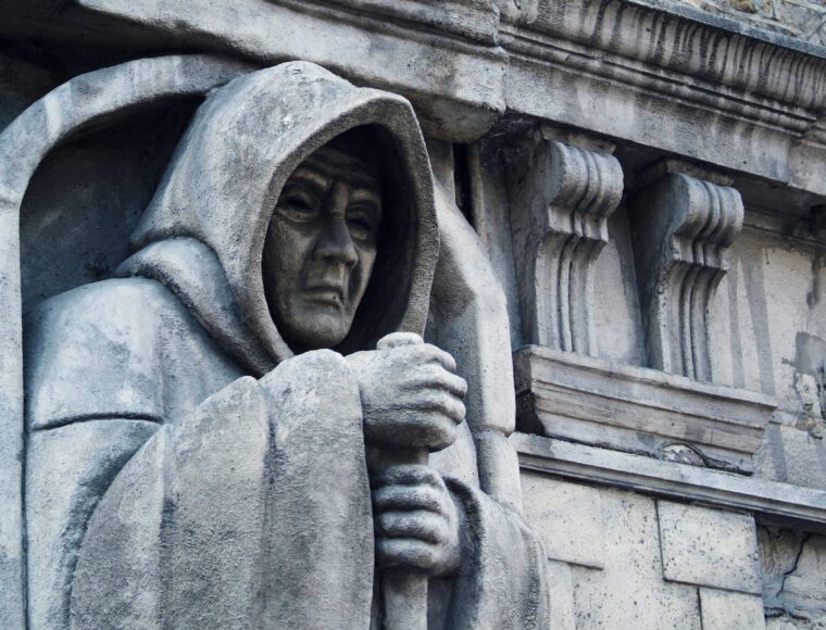 The death statue outside the London Dungeon, UK on Halloween.